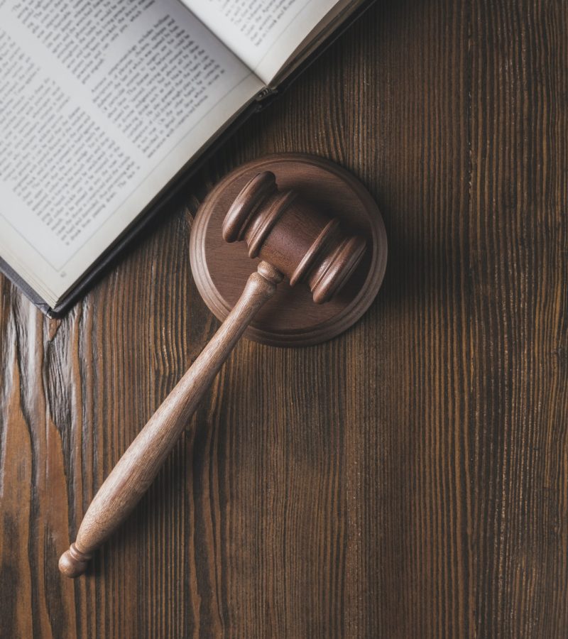 opened-juridical-book-with-hammer-on-wooden-table-law-concept.jpg